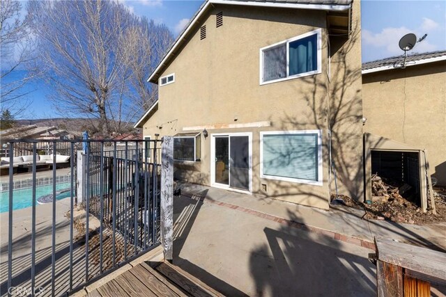 11874 Cornell Ln, Yucaipa, CA 92399 - back of house featuring stucco siding and a patio area