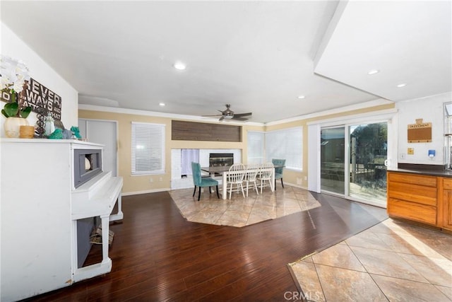 11874 Cornell Ln, Yucaipa, CA 92399 - dining room featuring a ceiling fan, crown molding, wood finished floors, a glass covered fireplace, and recessed lighting