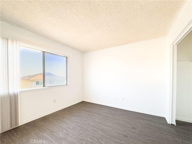 3501 20th St, Highland, CA 92346 - empty room with dark wood finished floors and a textured ceiling
