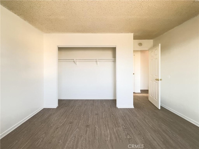 3501 20th St, Highland, CA 92346 - unfurnished bedroom with a closet, a textured ceiling, dark wood-style flooring, and baseboards