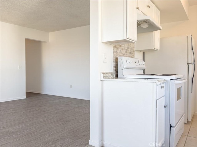 3501 20th St, Highland, CA 92346 - kitchen with white cabinets, light wood-type flooring, a textured ceiling, under cabinet range hood, and white electric range