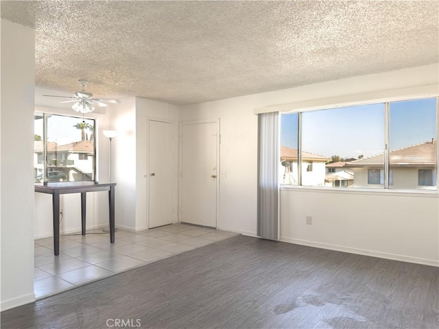 3501 20th St, Highland, CA 92346 - spare room with a textured ceiling, baseboards, a ceiling fan, and wood finished floors