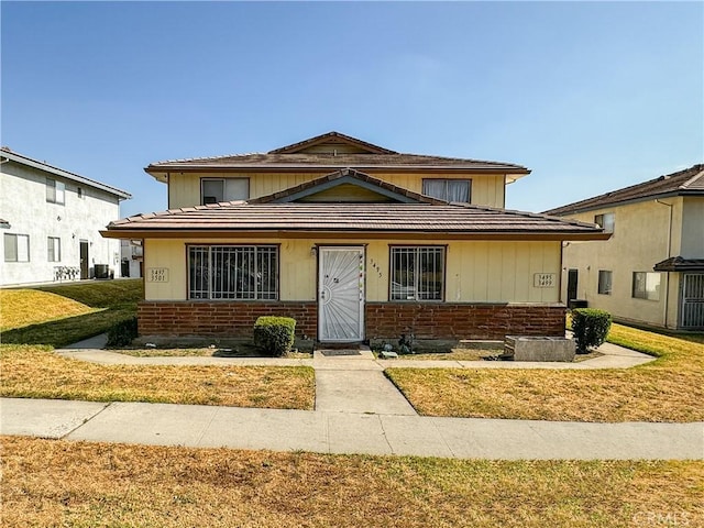 3501 20th St, Highland, CA 92346 - view of front of house with a front yard and brick siding
