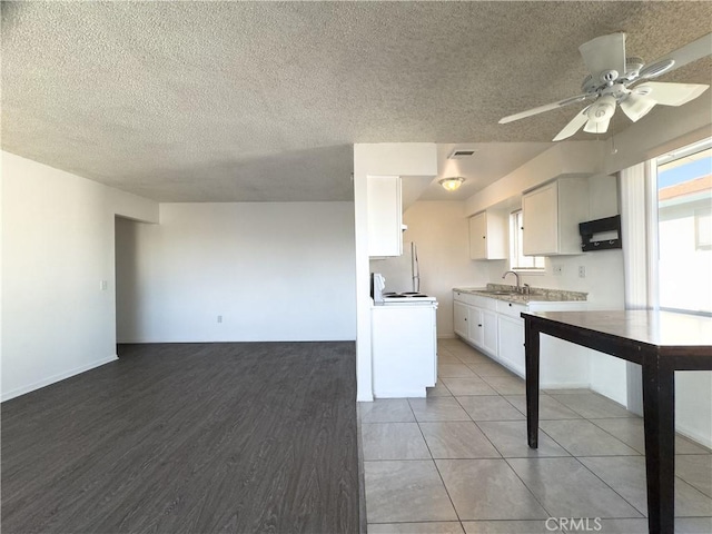 3501 20th St, Highland, CA 92346 - kitchen featuring white cabinets, light countertops, white range with electric cooktop, a textured ceiling, and a ceiling fan
