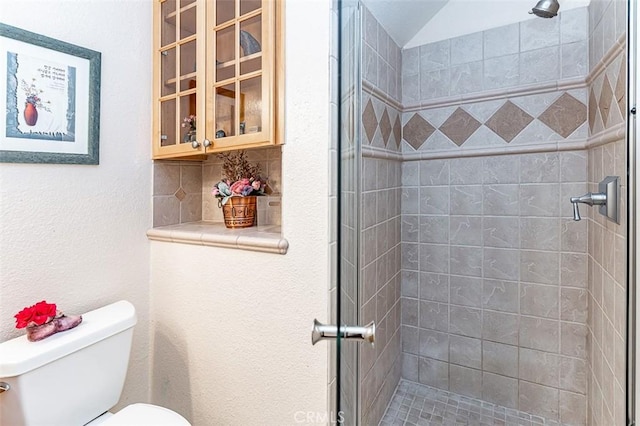 full bathroom with backsplash, a shower stall, and toilet