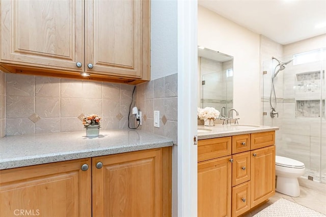 full bathroom with vanity, backsplash, a stall shower, and tile patterned floors