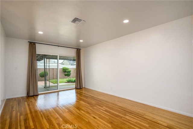 spare room with visible vents, recessed lighting, light wood-style floors, and baseboards