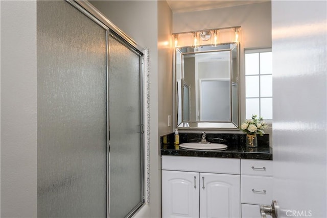 full bath with vanity and an enclosed shower
