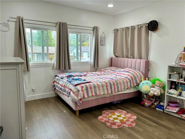 bedroom with recessed lighting, baseboards, and wood finished floors
