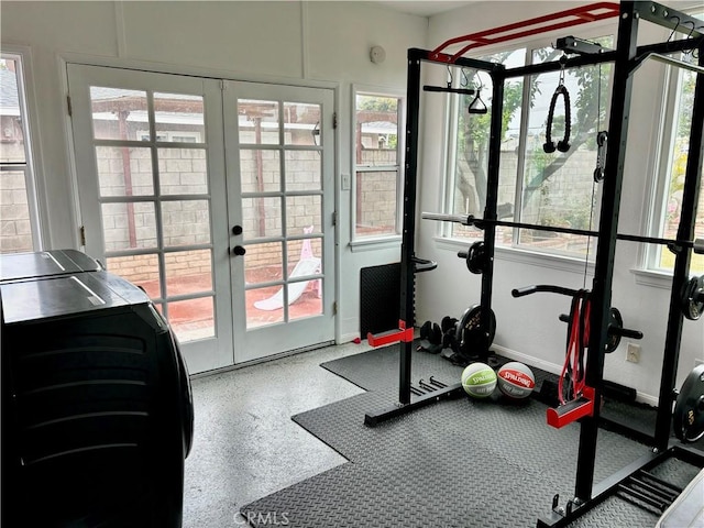 exercise area with baseboards, a wealth of natural light, and french doors
