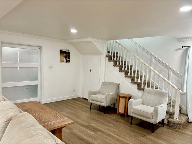 living room with recessed lighting, baseboards, wood finished floors, and stairway