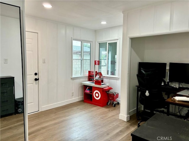 home office with light wood-style floors, baseboards, a decorative wall, and recessed lighting
