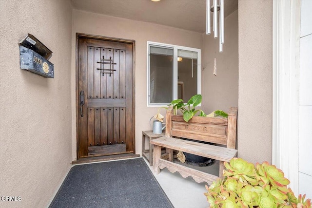 view of exterior entry featuring stucco siding