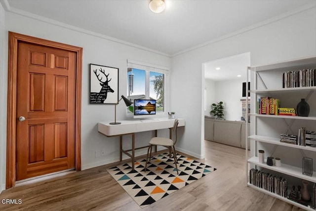office area with crown molding, wood finished floors, and baseboards