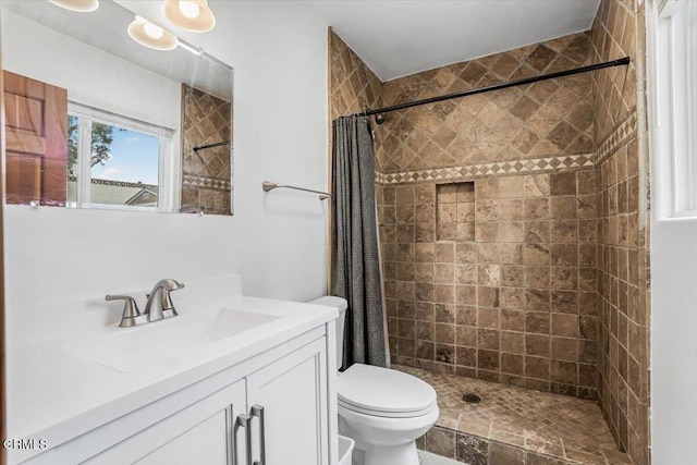 full bath with vanity, toilet, and a stall shower