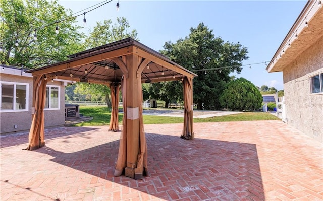 view of patio / terrace featuring fence and a gazebo