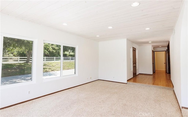 unfurnished room featuring carpet flooring, baseboards, and recessed lighting