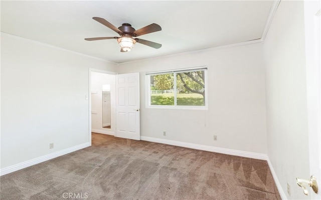 unfurnished bedroom featuring baseboards, crown molding, and carpet floors