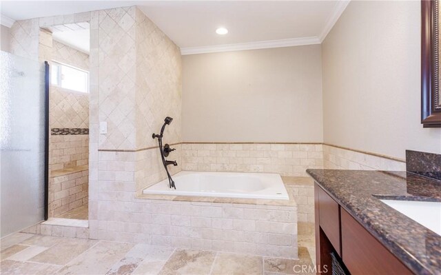bathroom with walk in shower, ornamental molding, a garden tub, and vanity