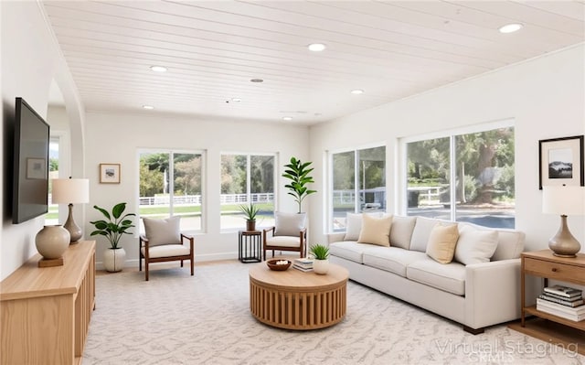 living area with wooden ceiling, light carpet, and a wealth of natural light