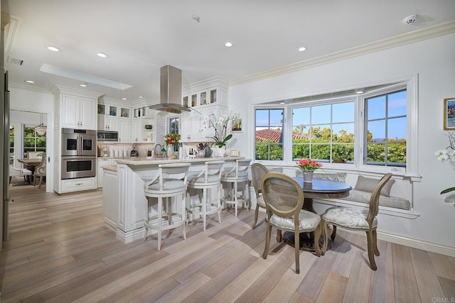 6019 La Flecha, Rancho Santa Fe, CA 92067 - dining room with recessed lighting, ornamental molding, a healthy amount of sunlight, and light wood-type flooring