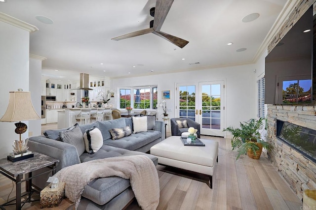6019 La Flecha, Rancho Santa Fe, CA 92067 - living room featuring ornamental molding, visible vents, a fireplace, light wood finished floors, and a ceiling fan