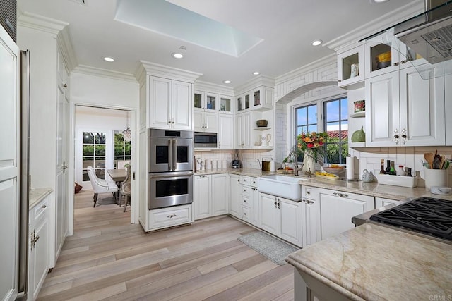 6019 La Flecha, Rancho Santa Fe, CA 92067 - kitchen with stainless steel appliances, open shelves, light wood-type flooring, crown molding, and decorative backsplash