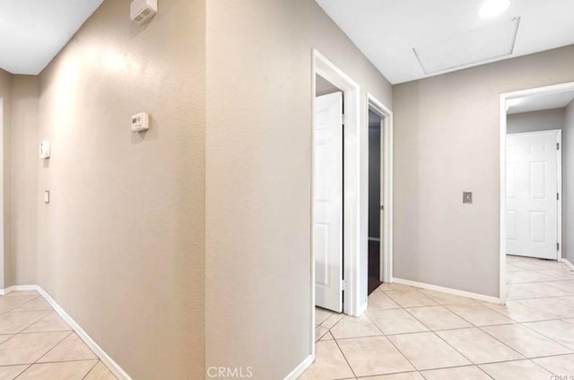 25624 Driftview Cir, Menifee, CA 92584 - hallway with light tile patterned floors, attic access, and baseboards