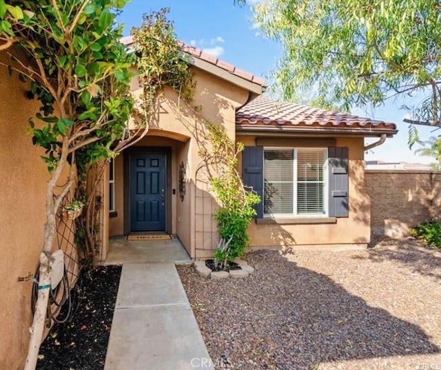 25624 Driftview Cir, Menifee, CA 92584 - entrance to property with a tiled roof, stucco siding, and fence