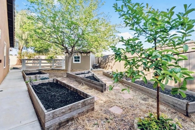 25624 Driftview Cir, Menifee, CA 92584 - fenced backyard featuring a garden, a shed, and an outdoor structure