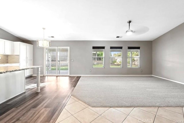 25624 Driftview Cir, Menifee, CA 92584 - unfurnished living room featuring baseboards, ceiling fan, and light wood-style flooring