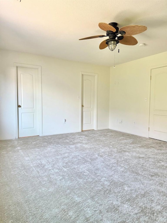 unfurnished room featuring a ceiling fan and carpet floors