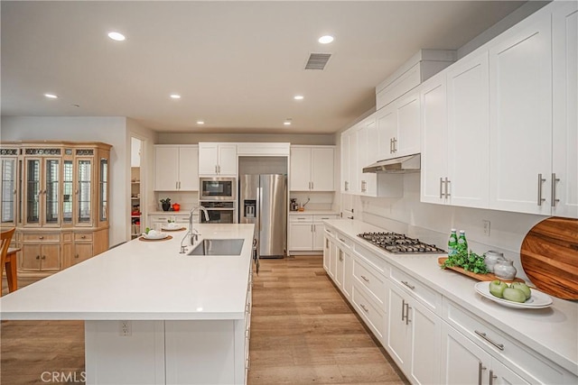 12931 Lotus St, Garden Grove, CA 92840 - kitchen with a sink, stainless steel appliances, recessed lighting, under cabinet range hood, and white cabinets
