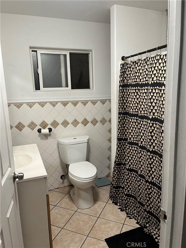 7650 El Vino Way, Buena Park, CA 90620 - full bath featuring vanity, tile patterned floors, a wainscoted wall, tile walls, and curtained shower