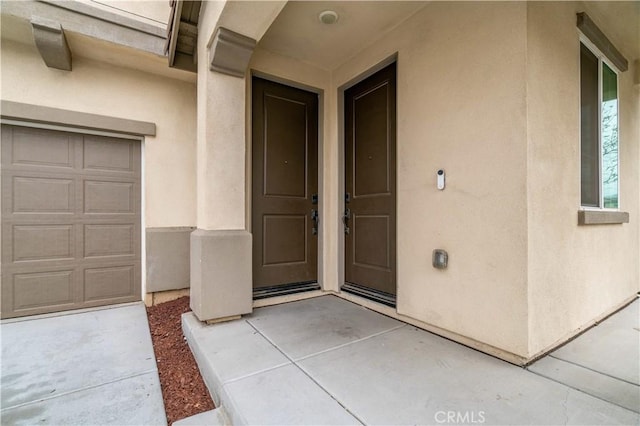 14667 Gulfstream Ln, Moreno Valley, CA 92553 - property entrance with stucco siding and a garage
