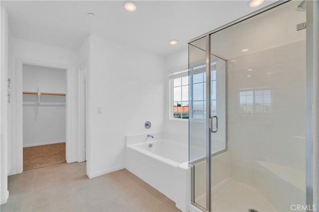 14667 Gulfstream Ln, Moreno Valley, CA 92553 - bathroom with a stall shower, tile patterned flooring, a walk in closet, baseboards, and a garden tub
