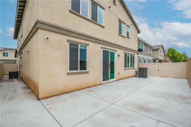 14667 Gulfstream Ln, Moreno Valley, CA 92553 - back of property with stucco siding, a patio area, and central AC