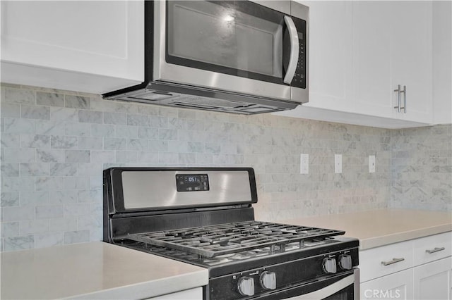 14667 Gulfstream Ln, Moreno Valley, CA 92553 - kitchen featuring stainless steel microwave, tasteful backsplash, gas stove, light countertops, and white cabinets