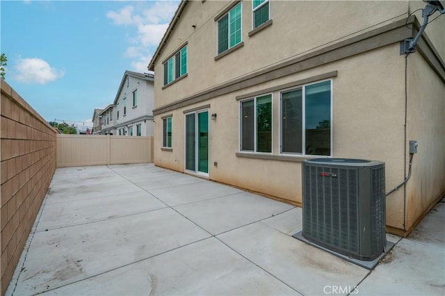 14667 Gulfstream Ln, Moreno Valley, CA 92553 - back of property with central AC unit, stucco siding, a fenced backyard, and a patio