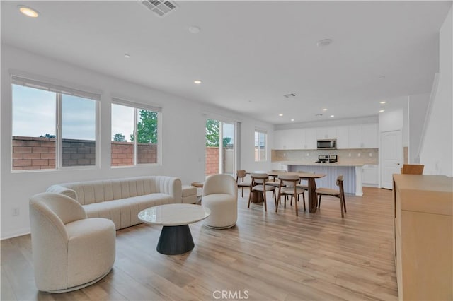 14667 Gulfstream Ln, Moreno Valley, CA 92553 - living room with light wood-style flooring, visible vents, and recessed lighting
