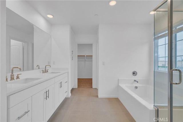 14667 Gulfstream Ln, Moreno Valley, CA 92553 - bathroom featuring baseboards, tile patterned flooring, a garden tub, and a sink