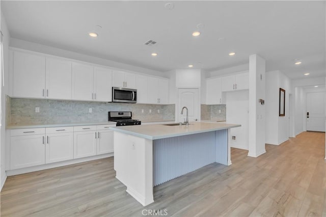 14667 Gulfstream Ln, Moreno Valley, CA 92553 - kitchen featuring a sink, stainless steel appliances, white cabinets, visible vents, and light countertops