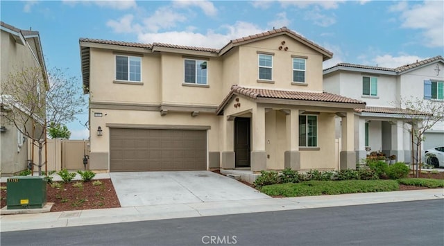 14667 Gulfstream Ln, Moreno Valley, CA 92553 - view of front of property featuring a tiled roof, covered porch, an attached garage, stucco siding, and concrete driveway