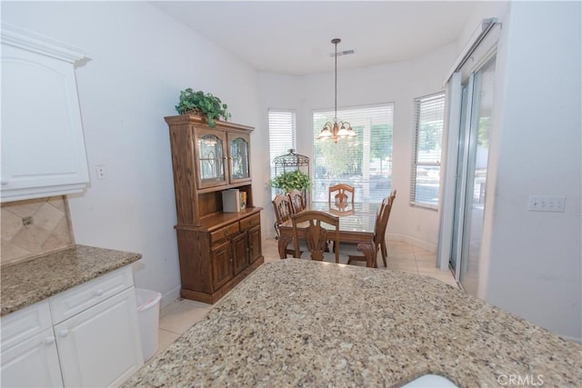 1490 N Dewitt Ave, Clovis, CA 93619 - dining room featuring a chandelier, baseboards, light tile patterned flooring, and visible vents