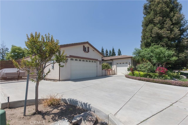 1490 N Dewitt Ave, Clovis, CA 93619 - ranch-style house featuring driveway, stucco siding, a garage, and fence