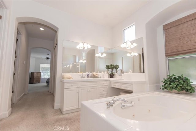 1490 N Dewitt Ave, Clovis, CA 93619 - bathroom with vanity, a whirlpool tub, connected bathroom, and ceiling fan with notable chandelier