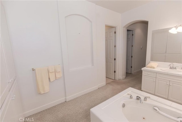 1490 N Dewitt Ave, Clovis, CA 93619 - bathroom with baseboards, a tub with jets, and vanity