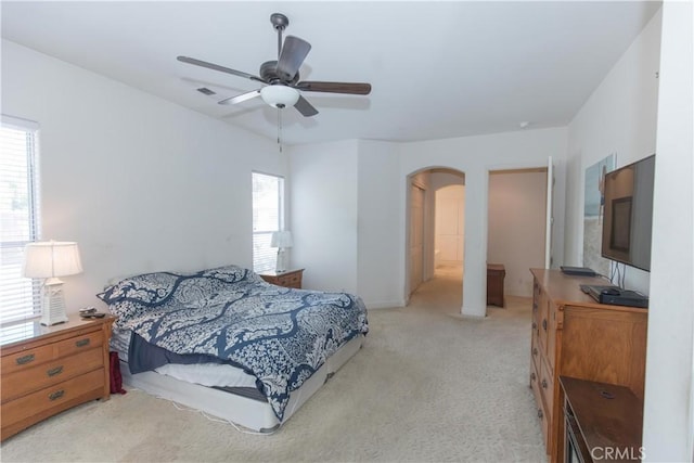 1490 N Dewitt Ave, Clovis, CA 93619 - carpeted bedroom featuring visible vents, a ceiling fan, and arched walkways