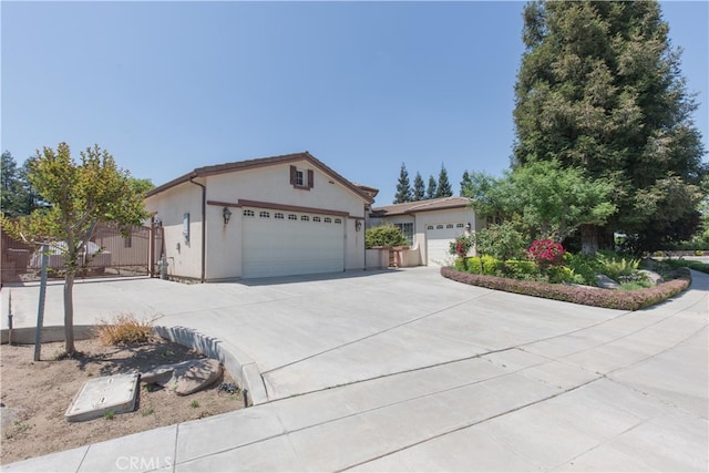 1490 N Dewitt Ave, Clovis, CA 93619 - ranch-style house with concrete driveway, an attached garage, and stucco siding