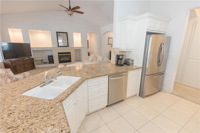 1490 N Dewitt Ave, Clovis, CA 93619 - kitchen featuring a sink, open floor plan, ceiling fan, arched walkways, and appliances with stainless steel finishes